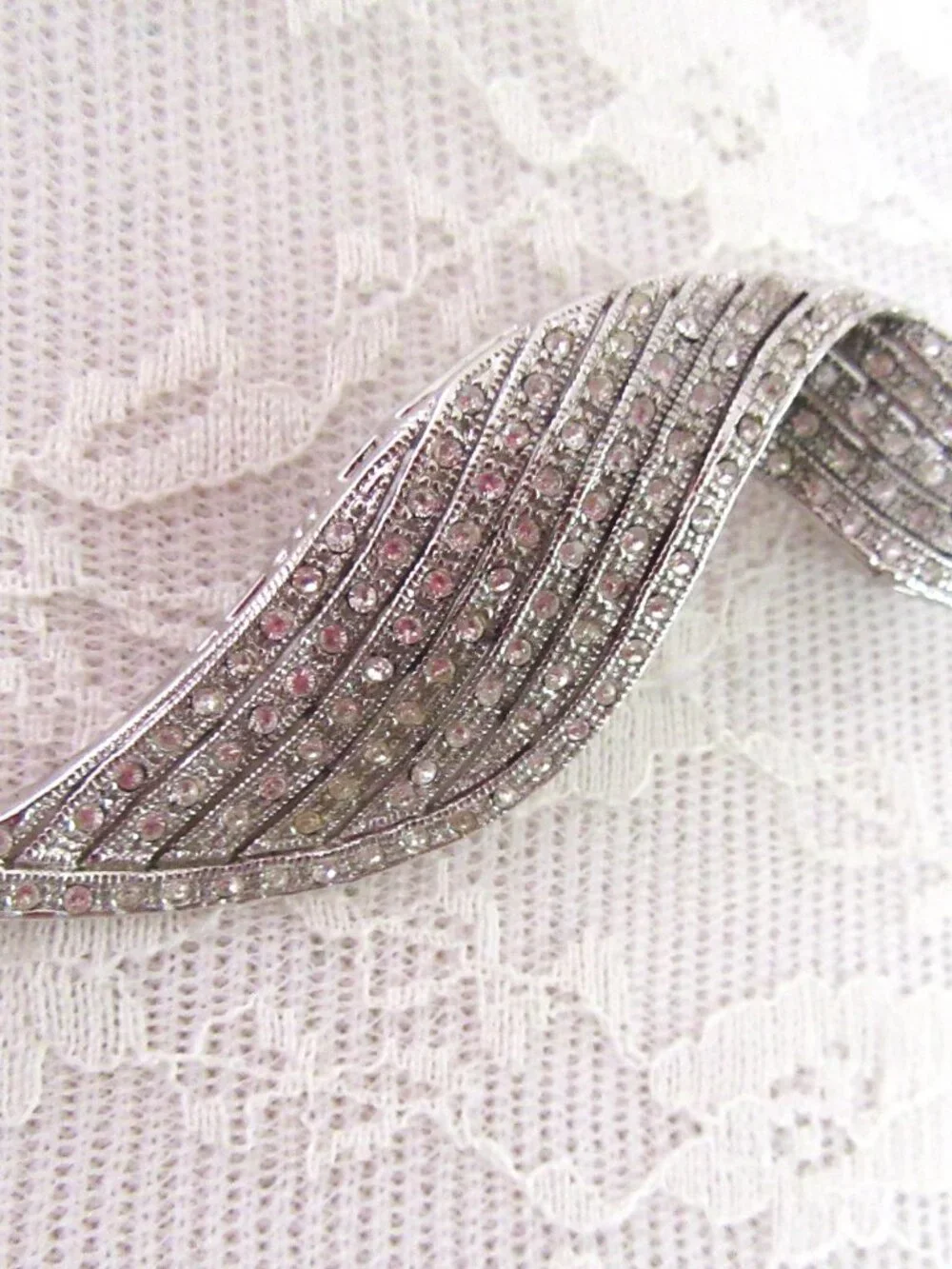 Clear pave rhinestone free form ribbon brooch in silver tone setting